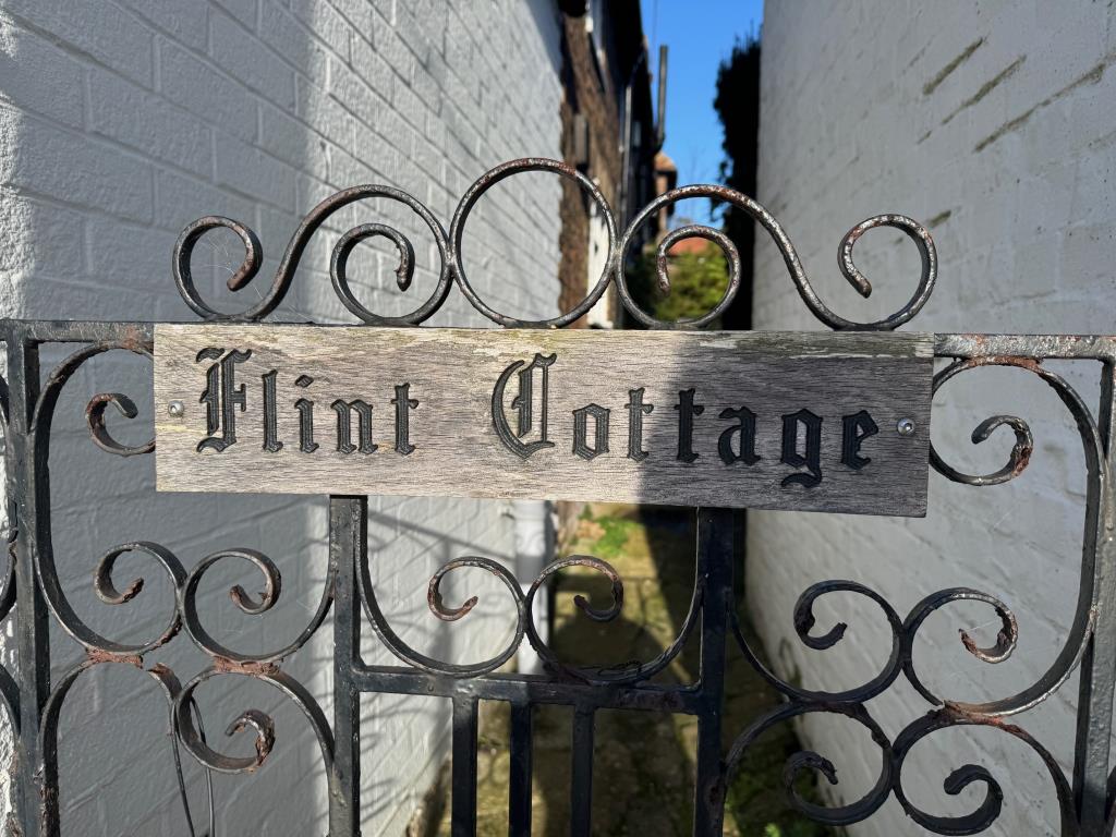 Lot: 154 - SEMI-DETACHED COTTAGE IN NEED OF IMPROVEMENT - Flint Cottage sign